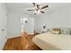 Cozy bedroom featuring hardwood floors, a ceiling fan, and a comfortable bed at 480 Whitt Ave, Burlington, NC 27215