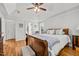 Bright primary bedroom featuring tray ceiling, hardwood floors, and a view of the outdoors at 480 Whitt Ave, Burlington, NC 27215