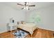Comfortable bedroom with hardwood floors, a ceiling fan, and a side table for reading at 480 Whitt Ave, Burlington, NC 27215