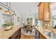 Bright dining area featuring a wood table, neutral chairs, and ample natural light at 480 Whitt Ave, Burlington, NC 27215