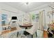 Traditional dining room with seating, bright windows, and view to living area at 480 Whitt Ave, Burlington, NC 27215