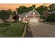 Beautiful brick home with a well-manicured lawn and two-car garage under a dramatic sunset sky at 480 Whitt Ave, Burlington, NC 27215
