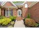 Inviting front entrance of brick home with landscaped garden and arched doorway with decorative wreath at 480 Whitt Ave, Burlington, NC 27215