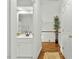 Bright hallway leading to updated bathroom with white vanity and modern fixtures at 480 Whitt Ave, Burlington, NC 27215