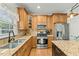 Bright kitchen featuring granite countertops, stainless steel appliances, and custom wood cabinetry at 480 Whitt Ave, Burlington, NC 27215