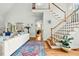 Bright living room featuring a staircase, light colored sofa, hardwood floors, and an area rug at 480 Whitt Ave, Burlington, NC 27215