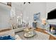Open-concept living room with a high ceiling, hardwood floors and an inviting fireplace at 480 Whitt Ave, Burlington, NC 27215