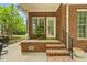 Back patio with steps and brick pillars, nice plants and space for a sitting area at 480 Whitt Ave, Burlington, NC 27215
