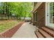 Outdoor patio with brick walls, providing a peaceful setting with adjacent green space at 480 Whitt Ave, Burlington, NC 27215