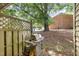Outdoor barbecue area with gas grill, wood fence, and mature trees providing shade at 4822 Blue Bird Ct # B, Raleigh, NC 27606