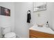 Small bathroom with toilet, sink, towel bar, and small mirror at 4822 Blue Bird Ct # B, Raleigh, NC 27606