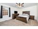 Comfortable bedroom featuring a ceiling fan, a window with curtains, and modern wooden furniture at 4822 Blue Bird Ct # B, Raleigh, NC 27606
