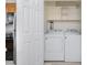 Laundry room with washer, dryer, shelving and a view of the kitchen at 4822 Blue Bird Ct # B, Raleigh, NC 27606