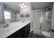 Bathroom featuring a double sink vanity with framed mirror and a tiled glass door shower enclosure at 49 Pumpkin Hill Rdg, Clayton, NC 27520