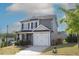 Well-maintained home with two-car garage, complemented by a green lawn and mature landscaping at 49 Pumpkin Hill Rdg, Clayton, NC 27520