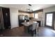Modern kitchen features an island with seating, stainless appliances, and lots of natural light from a glass door at 49 Pumpkin Hill Rdg, Clayton, NC 27520