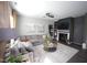 Cozy living room with large sectional, decorative rug, and fireplace creates a warm gathering spot for relaxation at 49 Pumpkin Hill Rdg, Clayton, NC 27520