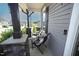 Inviting front porch with seating offers a relaxing outdoor space with stone and wood elements at 49 Pumpkin Hill Rdg, Clayton, NC 27520