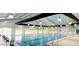 Bright indoor swimming pool with lap lanes, pennant flags, and large windows to let in plenty of light at 49 Pumpkin Hill Rdg, Clayton, NC 27520