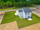 Aerial view of the backyard featuring a patio area, a newly installed lawn, and picturesque scenery at 499 Beacon Hill Rd # 30, Lillington, NC 27546