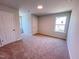 A carpeted bedroom with two closets and a window for natural light at 499 Beacon Hill Rd # 30, Lillington, NC 27546
