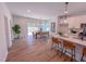 Dining room with a modern light fixture, and sliding glass doors that lead to the backyard at 499 Beacon Hill Rd # 30, Lillington, NC 27546
