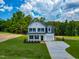 Beautiful two-story home with a well-kept lawn and an attached garage, surrounded by lush trees at 499 Beacon Hill Rd # 30, Lillington, NC 27546