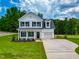 Charming two-story home featuring white siding, black shutters and a well manicured lawn at 499 Beacon Hill Rd # 30, Lillington, NC 27546