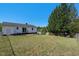 Fenced backyard with patio, well-maintained lawn and mature trees at 500 Lemontree Ct, Graham, NC 27253
