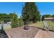 Backyard features a fire pit, patio, and green, fenced-in yard with mature trees at 500 Lemontree Ct, Graham, NC 27253