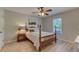 Well-lit bedroom features a wood-frame bed, wood-look floors, and a large window at 500 Lemontree Ct, Graham, NC 27253