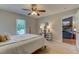 Bedroom showcases a four-poster bed, wood-look floors, and a view to the fireplace in the living room at 500 Lemontree Ct, Graham, NC 27253
