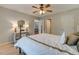 Spacious bedroom with wood-look flooring and views into the dining area and hallway at 500 Lemontree Ct, Graham, NC 27253