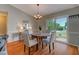 Cozy dining area with hardwood floors, a chandelier, and sliding glass doors to the exterior at 500 Lemontree Ct, Graham, NC 27253