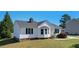 Charming home with a bay window, a manicured lawn and mature landscaping at 500 Lemontree Ct, Graham, NC 27253