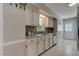 Traditional kitchen featuring white cabinets, stainless steel sink, and mosaic tile backsplash at 500 Lemontree Ct, Graham, NC 27253