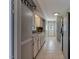 Galley kitchen featuring tile floors, white cabinets, and modern appliances at 500 Lemontree Ct, Graham, NC 27253
