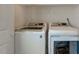 Bright laundry room with a modern, white front-load washer and dryer at 500 Lemontree Ct, Graham, NC 27253