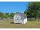 White storage shed with double doors in the fenced in backyard at 500 Lemontree Ct, Graham, NC 27253