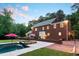 Spacious brick home with an in-ground pool and stone patio, perfect for outdoor living at 500 Old Greensboro Rd, Chapel Hill, NC 27516