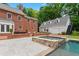 Backyard view with in-ground pool, spa, and pool house at 500 Old Greensboro Rd, Chapel Hill, NC 27516
