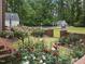 Beautiful backyard gardens with brick accents leading to pool and poolhouse at 500 Old Greensboro Rd, Chapel Hill, NC 27516