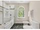 Spacious bathroom with tiled shower, soaking tub and marble floors at 500 Old Greensboro Rd, Chapel Hill, NC 27516