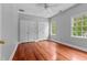 Spacious bedroom with hardwood floors, double closets, and a window offering natural light at 500 Old Greensboro Rd, Chapel Hill, NC 27516