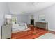 Light filled bedroom boasts a ceiling fan, fireplace, and hardwood floors at 500 Old Greensboro Rd, Chapel Hill, NC 27516