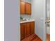 Butler's pantry with wooden cabinets, white countertop, sink, and wood floor at 500 Old Greensboro Rd, Chapel Hill, NC 27516