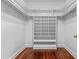 Large walk-in closet with custom shelving and hardwood floors at 500 Old Greensboro Rd, Chapel Hill, NC 27516