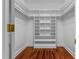 Spacious walk-in closet with custom shelving and hardwood floors at 500 Old Greensboro Rd, Chapel Hill, NC 27516