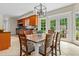 Open dining area with six chairs, french doors to yard, and direct access to the adjacent kitchen at 500 Old Greensboro Rd, Chapel Hill, NC 27516
