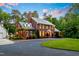 Charming brick home with lush landscaping, circular driveway, and well-maintained lawn at 500 Old Greensboro Rd, Chapel Hill, NC 27516